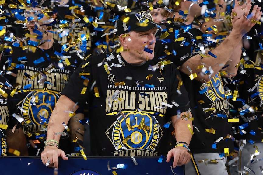 A celebratory scene featuring a group of fans wearing 2022 World Series champion t-shirts, surrounded by colorful confetti.